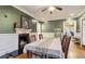 Dining room featuring a fireplace, crown molding, hardwood floors, and connection to another room at 946 Highland Ne Vw, Atlanta, GA 30306