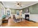 Bright dining room with a fireplace, hardwood floors, ceiling fan, and three large windows at 946 Highland Ne Vw, Atlanta, GA 30306