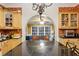 Kitchen with black countertops, wooden cabinets, and an archway view to a separate seating area at 946 Highland Ne Vw, Atlanta, GA 30306