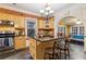 Bright kitchen featuring wooden cabinets, dark countertops, a center island with seating, and stainless steel appliances at 946 Highland Ne Vw, Atlanta, GA 30306