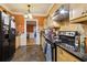 Well-lit kitchen featuring sleek black countertops, wooden cabinetry, and stainless steel appliances at 946 Highland Ne Vw, Atlanta, GA 30306