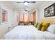 Bright bedroom with a ceiling fan, a bed with decorative pillows and hardwood floors at 215 Piedmont St # 1204, Atlanta, GA 30308