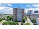 Apartment building showcasing a tall modern building with many windows with other buildings in the background at 215 Piedmont St # 1204, Atlanta, GA 30308