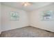 Bright bedroom with neutral carpet, two windows providing natural light, and a ceiling fan at 3459 Adkins Nw Rd, Atlanta, GA 30331