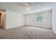 View of a spacious living room with neutral walls, carpet flooring, ceiling fan, and bright natural light at 3459 Adkins Nw Rd, Atlanta, GA 30331