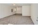 View of an empty, carpeted living room space with neutral walls, ceilings fans, and lighting at 3459 Adkins Nw Rd, Atlanta, GA 30331