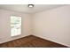 Bedroom with neutral walls, carpeted floor, and window for natural lighting at 5145 Otter Creek Run, Cumming, GA 30040