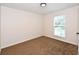 Bedroom with neutral walls, carpeted floor, and window for natural lighting at 5145 Otter Creek Run, Cumming, GA 30040