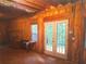 Unfinished basement with exposed wood framing, a small window and white double doors to the exterior at 7740 Berea Rd, Winston, GA 30187