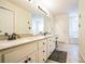 Bright bathroom with double sinks, granite counters, white cabinets, and tile flooring at 7740 Berea Rd, Winston, GA 30187
