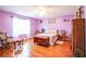 Colorful bedroom with hardwood floors, a ceiling fan, and a decorative chest at 7740 Berea Rd, Winston, GA 30187