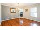 Bright dining room featuring hardwood floors, elegant chandelier, and view of adjacent kitchen area at 7740 Berea Rd, Winston, GA 30187