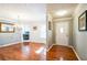 Bright dining room featuring hardwood floors, elegant chandelier, and view of adjacent kitchen area at 7740 Berea Rd, Winston, GA 30187