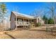 A quaint brick home featuring a cozy front porch, surrounded by a lush yard and mature trees at 7740 Berea Rd, Winston, GA 30187