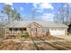 Charming brick home with a covered front porch and a well-manicured lawn in a peaceful neighborhood at 7740 Berea Rd, Winston, GA 30187