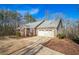 Charming brick house with a two-car garage and a long driveway in a wooded area at 7740 Berea Rd, Winston, GA 30187