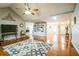 Inviting living room with vaulted ceilings, hardwood floors, built-in shelving, and a ceiling fan at 7740 Berea Rd, Winston, GA 30187