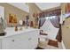 Well-lit bathroom with double sinks, a mirror, a bathtub with shower, and patterned tile flooring at 1070 River Valley Dr, Dacula, GA 30019