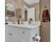 Well-maintained bathroom featuring a sink with gold fixtures, a mirror, and neutral-toned walls at 1070 River Valley Dr, Dacula, GA 30019