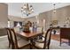 Formal dining room open to living room, with chandelier and classic furnishings at 1070 River Valley Dr, Dacula, GA 30019