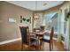 Elegant dining room area with hardwood floors, a window view, and modern lighting at 1070 River Valley Dr, Dacula, GA 30019