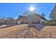 Exterior angle view of a traditional brick home with mature trees and landscaping at 1070 River Valley Dr, Dacula, GA 30019