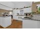 Well-lit kitchen showcasing white cabinets, granite counters, and modern appliances at 1070 River Valley Dr, Dacula, GA 30019