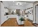 Open kitchen layout with white cabinetry, hardwood floors, and granite countertops at 1070 River Valley Dr, Dacula, GA 30019