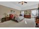 Bedroom featuring neutral carpeting, large dresser, ceiling fan, and natural light at 1070 River Valley Dr, Dacula, GA 30019