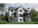 The back of the house shows a large lawn with a wooden deck, a stone deck, and lots of windows at 130 Lake Estates Dr, Roswell, GA 30075