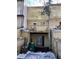 View of the multi-level exterior with sliding glass doors, wooden deck, and a fenced backyard with snow at 497 Prince Of Wales, Stone Mountain, GA 30083