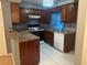 This kitchen features tile floors, wood cabinets, and light countertops at 497 Prince Of Wales, Stone Mountain, GA 30083