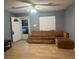 Cozy living room featuring wood floors, a ceiling fan, and a large window at 497 Prince Of Wales, Stone Mountain, GA 30083