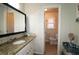 Bathroom featuring granite countertops, white cabinetry, with a view into the toilet room with a tile floor at 744 Dean Way, Lawrenceville, GA 30044