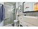 Modern bathroom featuring tiled shower with glass door and a marble top vanity at 744 Dean Way, Lawrenceville, GA 30044