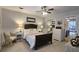 Bright bedroom featuring a ceiling fan, mirrors, neutral decor, and ample space at 744 Dean Way, Lawrenceville, GA 30044