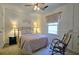 Serene bedroom with paneled accent wall, a comfortable bed, and a rocking chair, creating a relaxing atmosphere at 744 Dean Way, Lawrenceville, GA 30044