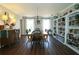 Formal dining area with a decorative chandelier and shelves filled with books, next to dining table at 744 Dean Way, Lawrenceville, GA 30044