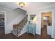 Inviting entryway with wooden staircase, vintage desk, and views to the kitchen and living spaces at 744 Dean Way, Lawrenceville, GA 30044