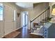 Inviting foyer with hardwood floors, staircase, and views to other rooms through doorway at 744 Dean Way, Lawrenceville, GA 30044