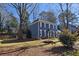 Well-maintained front yard with a classic colonial-style house and an inviting fire pit at 744 Dean Way, Lawrenceville, GA 30044