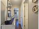 Inviting hallway with decoratively appointed shelving, wood-look flooring, and neutral paint at 744 Dean Way, Lawrenceville, GA 30044