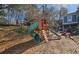 Backyard playground with tunnel slide is surrounded by a wood chip surface at 744 Dean Way, Lawrenceville, GA 30044