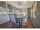 Relaxing screened porch with dining table and ceiling fan, blending indoor comfort with outdoor views at 744 Dean Way, Lawrenceville, GA 30044