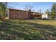 Expansive backyard featuring a two-story brick home with a spacious wooden deck and lush green lawn at 992 Yemassee Trl, Stone Mountain, GA 30083