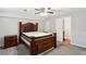 Spacious bedroom with a wooden bed frame and a ceiling fan at 992 Yemassee Trl, Stone Mountain, GA 30083