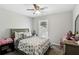 Bedroom features a ceiling fan, neutral carpet, and a queen bed at 992 Yemassee Trl, Stone Mountain, GA 30083