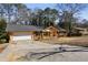 Exterior shot of a one-story home with a garage and a long, wide driveway at 992 Yemassee Trl, Stone Mountain, GA 30083