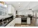 Kitchen area with white cabinets, granite countertops, stainless steel appliances, and wood floors at 992 Yemassee Trl, Stone Mountain, GA 30083