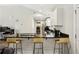 Kitchen featuring a breakfast bar with stools and stainless steel appliances and white cabinets at 992 Yemassee Trl, Stone Mountain, GA 30083